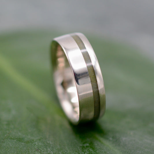 a close up of a wedding ring on a leaf
