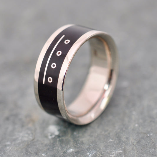 a black and silver ring with a white stripe