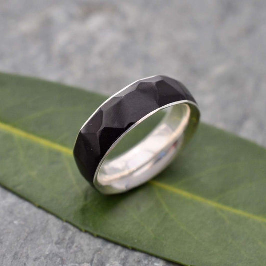 Multifaceted black coyol wood ring with recycled sterling silver interior