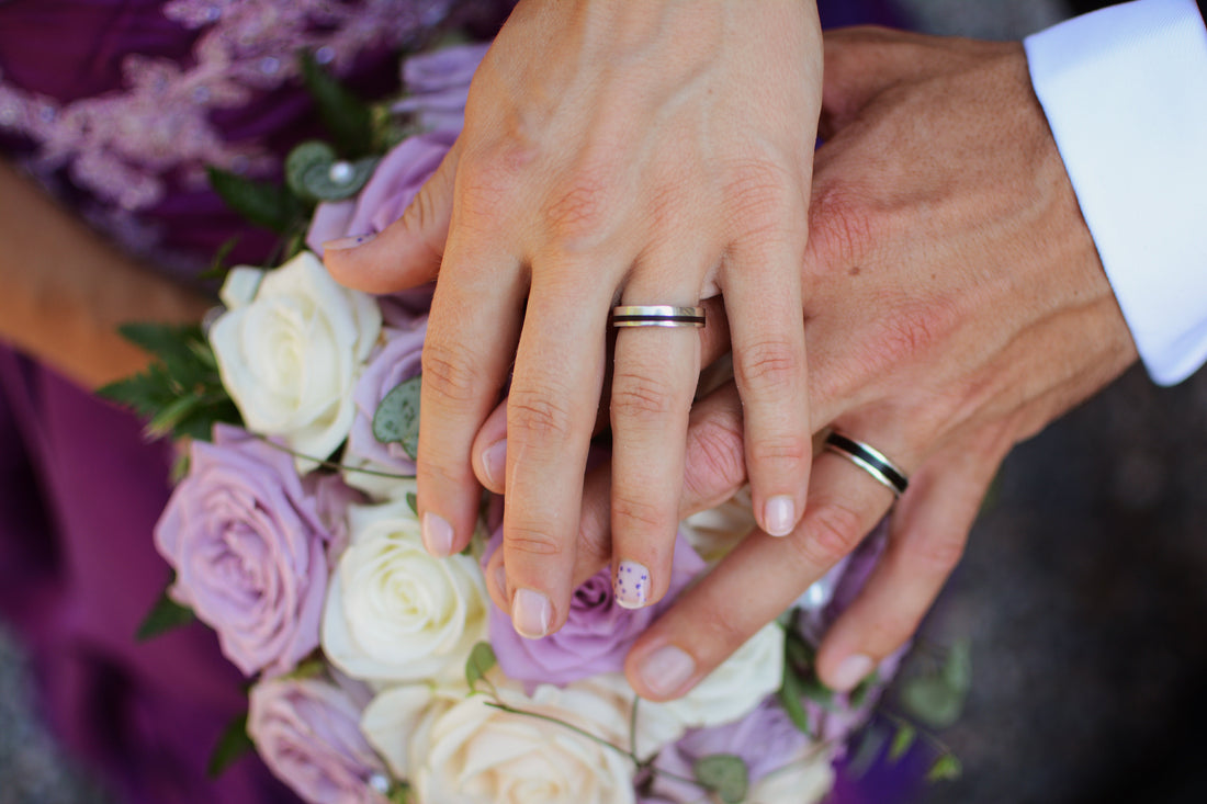 Wood Rings for Women worn by couple with floral bouquet in a romantic setting.