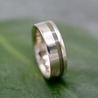 a close up of a wedding ring on a leaf