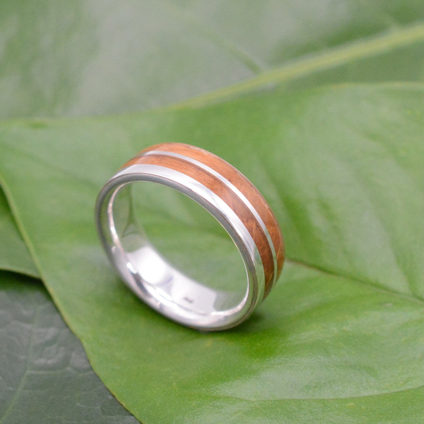 Handmade bourbon barrel wood wedding band with recycled sterling silver.