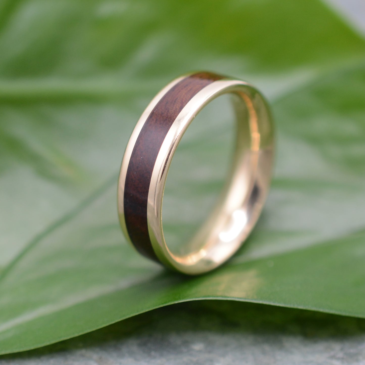 Mens Wood Wedding Band handcrafted with sustainable nacascolo wood and 14k recycled yellow gold in Louisville, KY