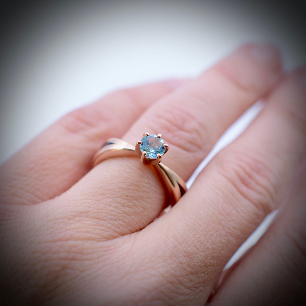 Aquamarine wood engagement ring with Kentucky walnut and recycled rose gold tapered band worn on hand