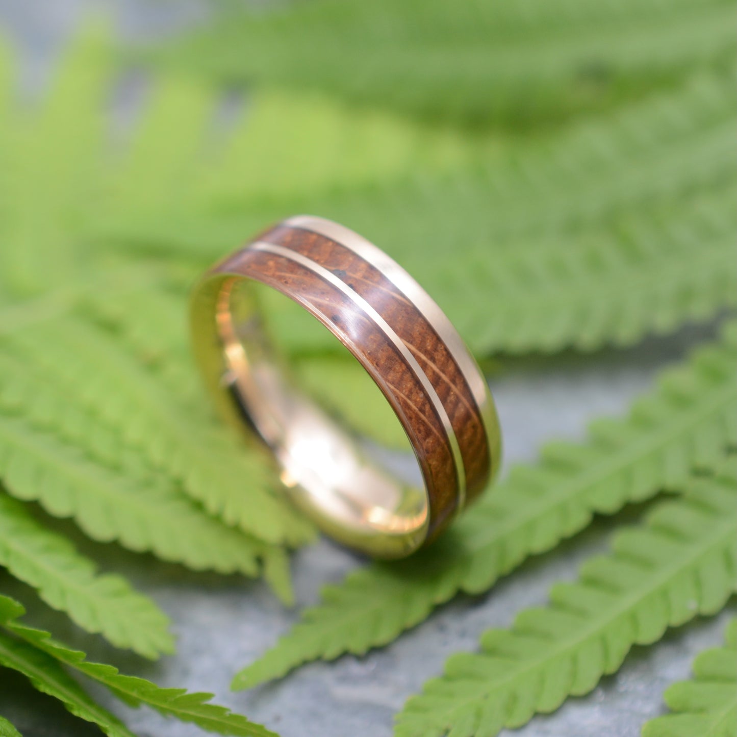 Custom bourbon barrel wedding band with 14k yellow gold. Handmade in Louisville, Kentucky by Naturaleza Organic Jewelry.