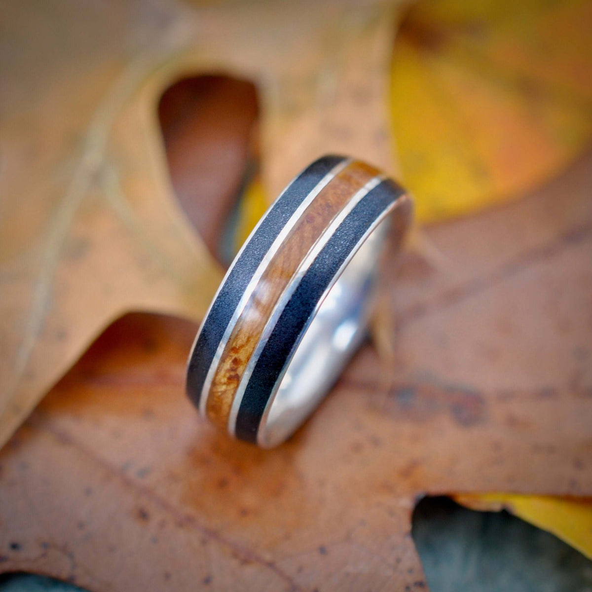 Juntos bourbon barrel ring with volcanic titanium sand edges and silver detail