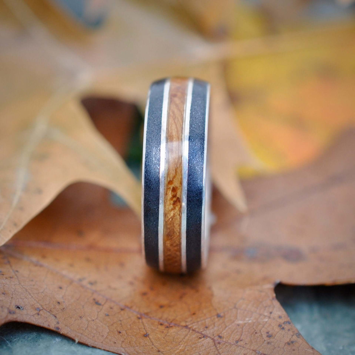 Comfort fit bourbon barrel ring with titanium sand and sterling silver
