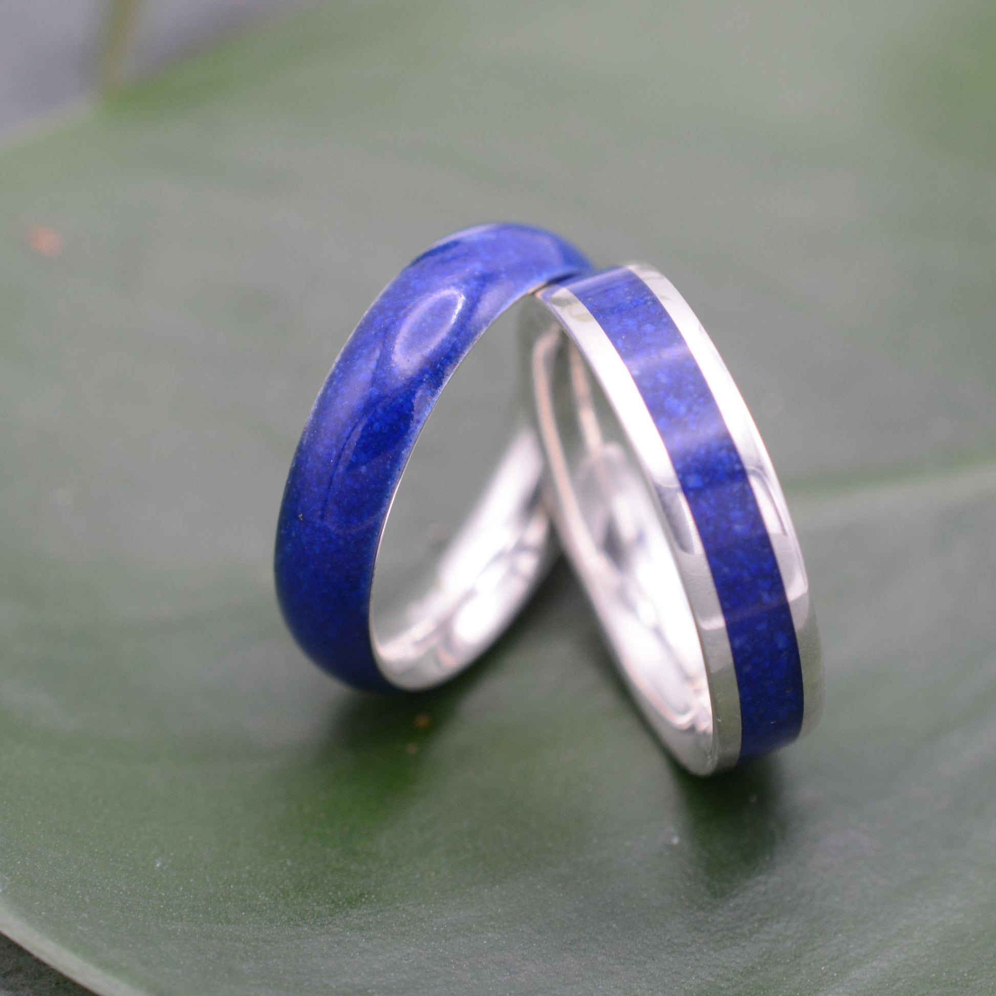 two wedding rings with blue and silver bands