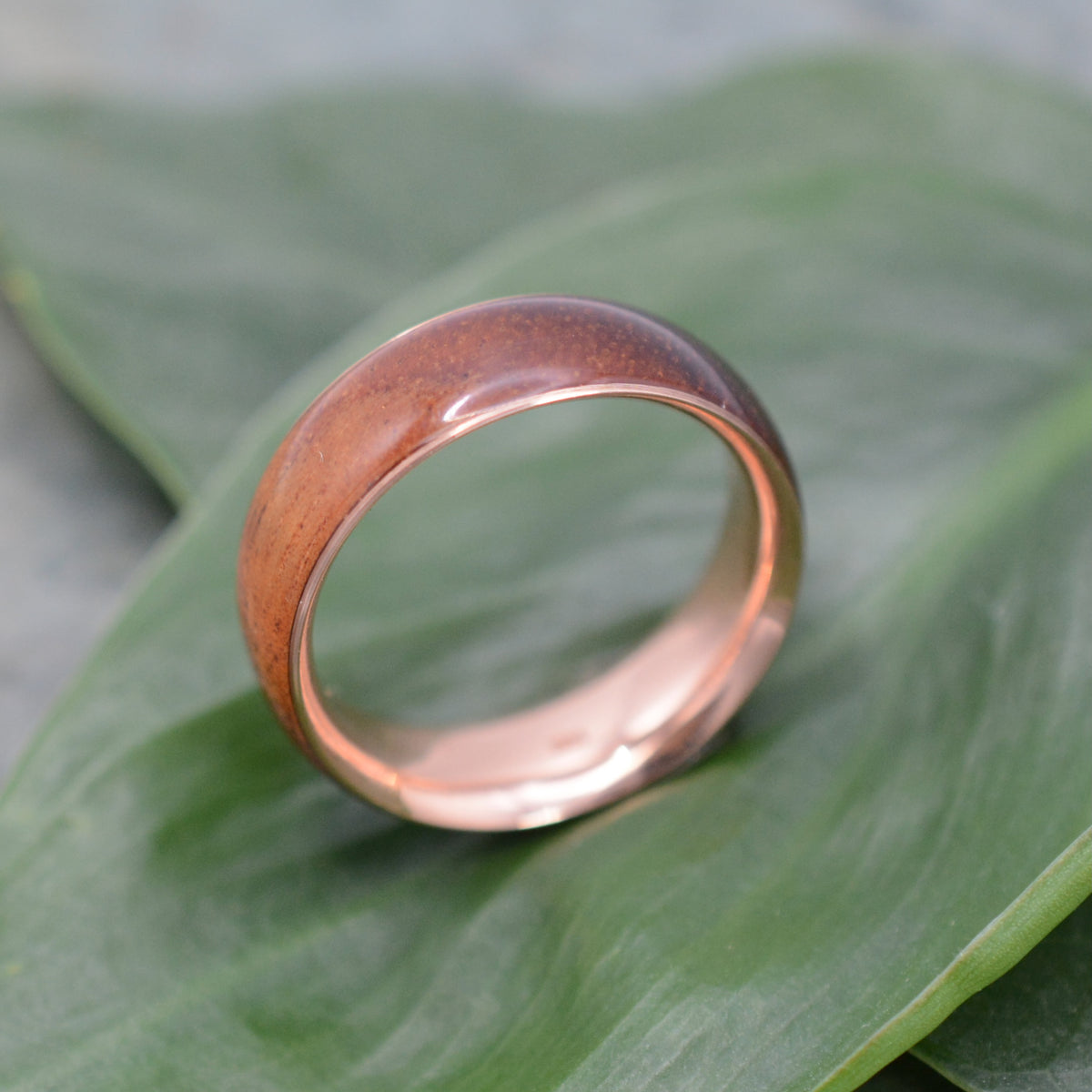 Koa wood wedding band with 14k recycled rose gold