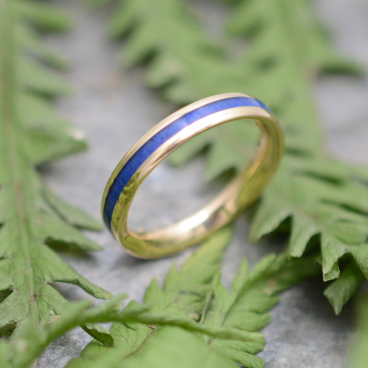 Yellow gold lapis ring showing blue stone inlay and gold edges