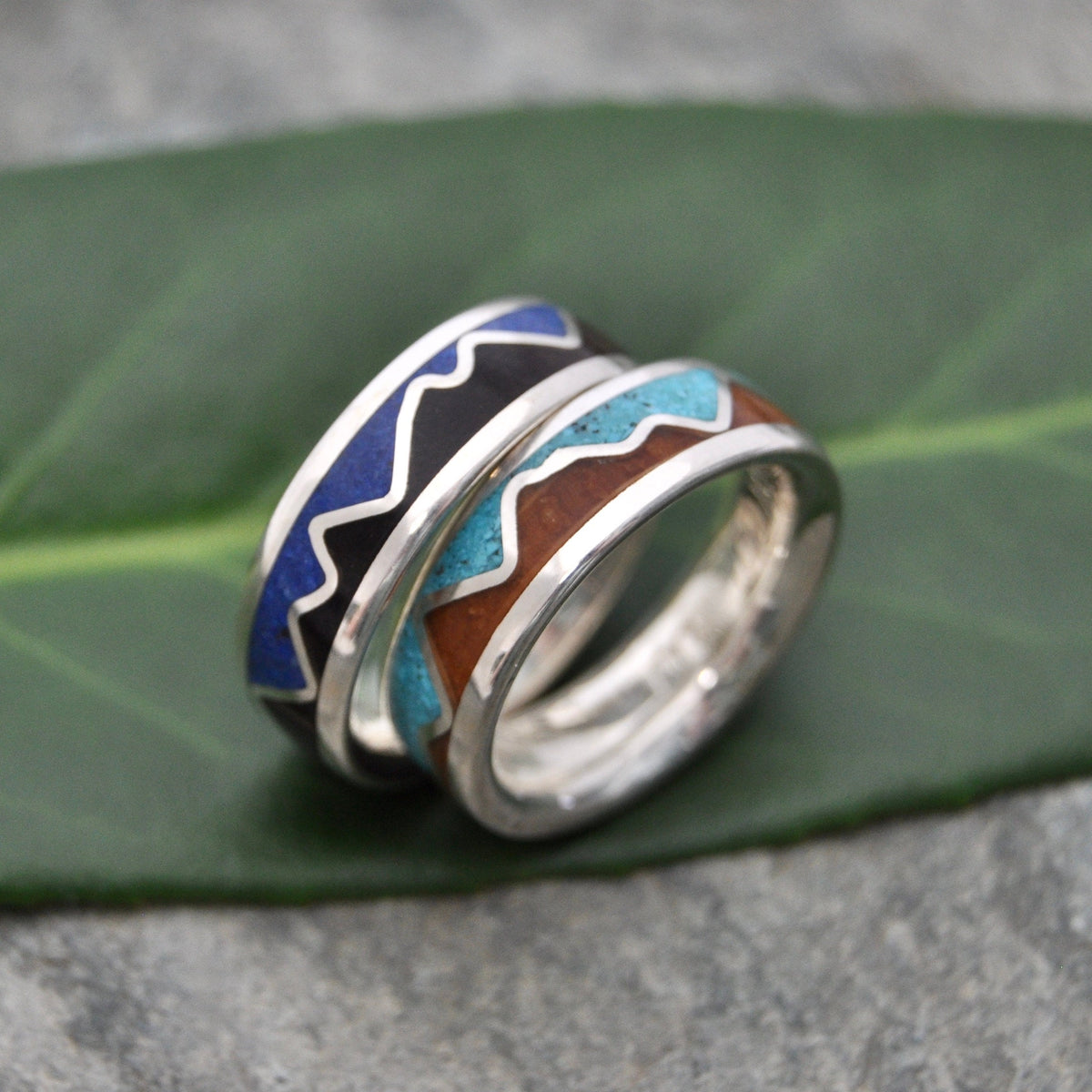 Lapis Lazuli Mountain Ring, Bourbon Barrel Wood and Sterling Silver on a green leaf background.
