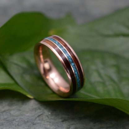 Rose gold wood ring showing turquoise stone and koa grain detail