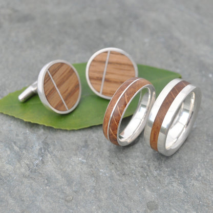 Bourbon barrel and silver wedding band showing wood grain detail