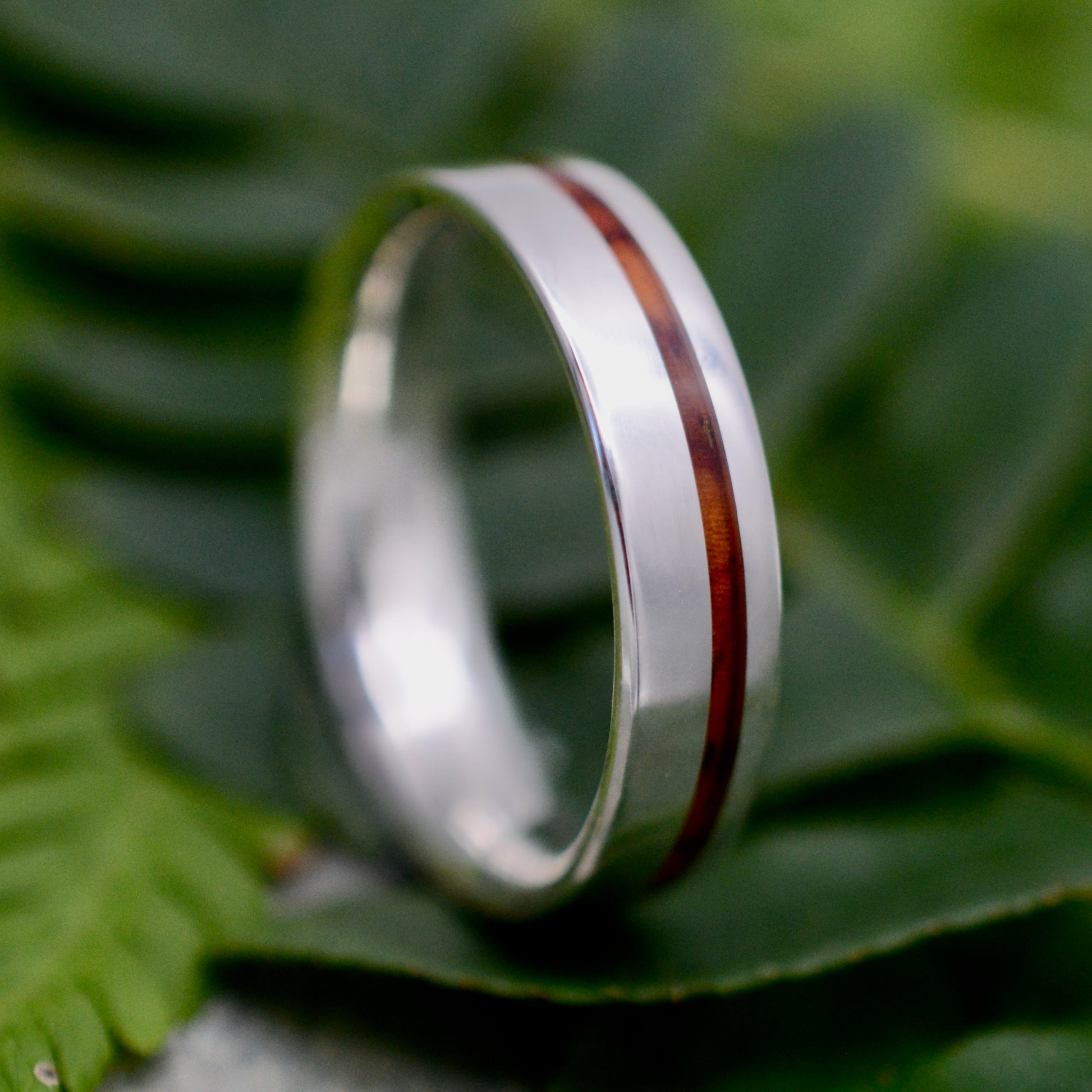 a wedding ring with a red stripe on it