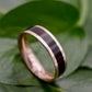 a wedding band with a black and gold stripe