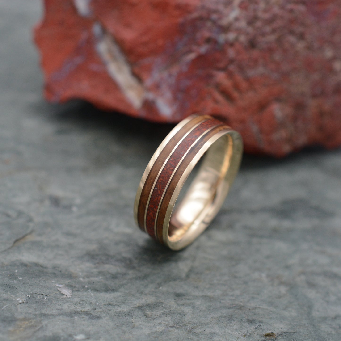a gold wedding band with a striped design