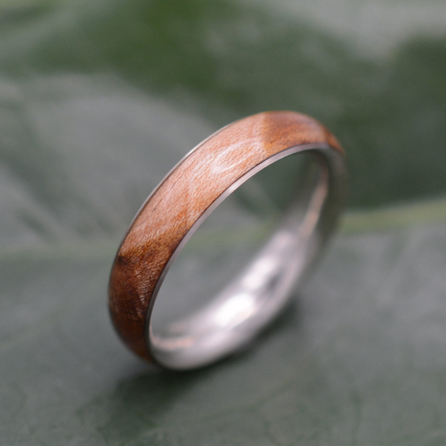 a wedding ring made of wood and silver