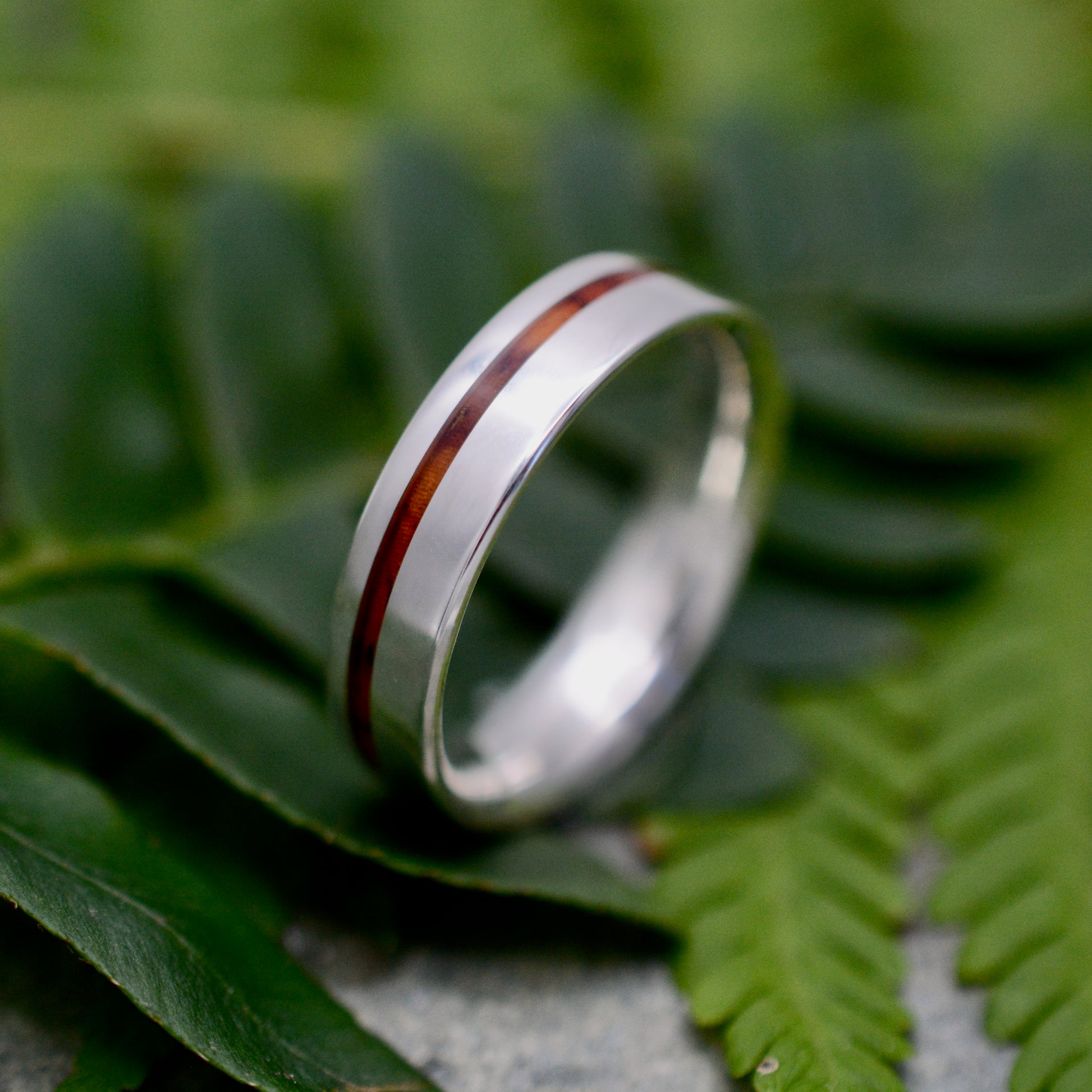 a couple of rings sitting on top of a leaf