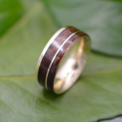 Asymmetric wood and yellow gold ring showing walnut grain detail
