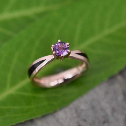 Top-down view of custom wooden engagement ring with blue-grey amethyst solitaire and rose gold finish, fully customizable wood and gemstone options