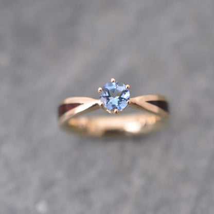 Custom wooden engagement ring with aquamarine solitaire and 14k yellow gold, cocobolo wood band, handcrafted by Naturaleza Organic Jewelry in Louisville Kentucky
