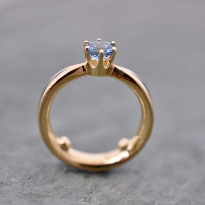 Side view of custom wooden engagement ring with aquamarine solitaire, cocobolo wood, and 14k yellow gold, fully customizable wood and gemstone options