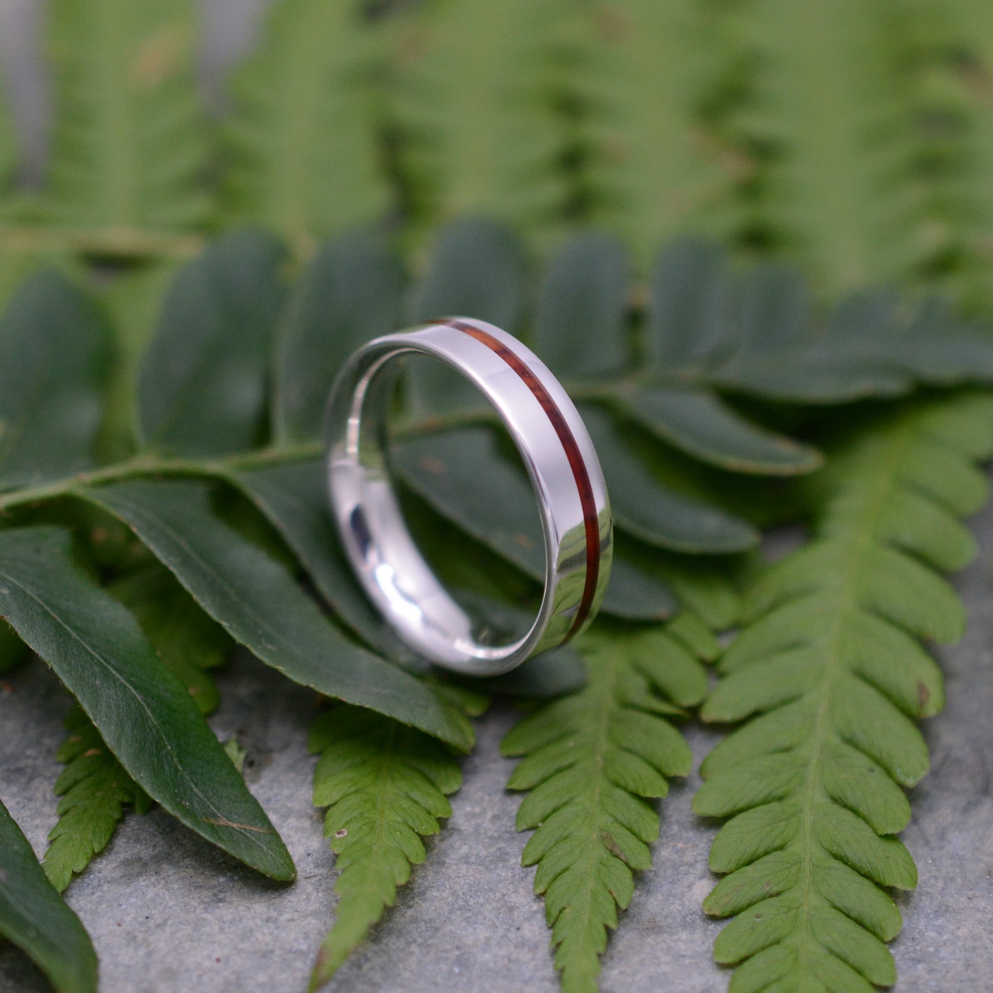 a couple of rings sitting on top of a leaf