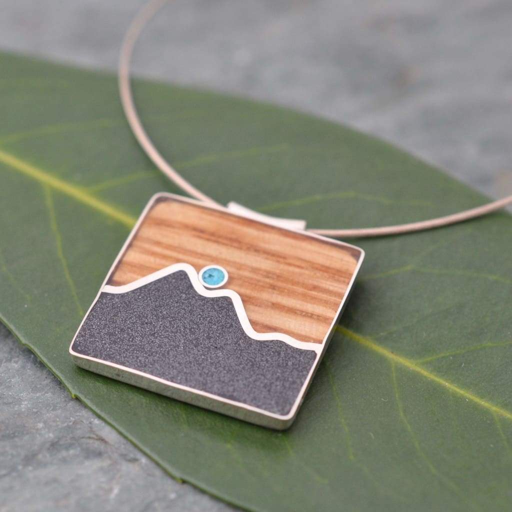 Turquoise and bourbon barrel mountain pendant with recycled sterling silver