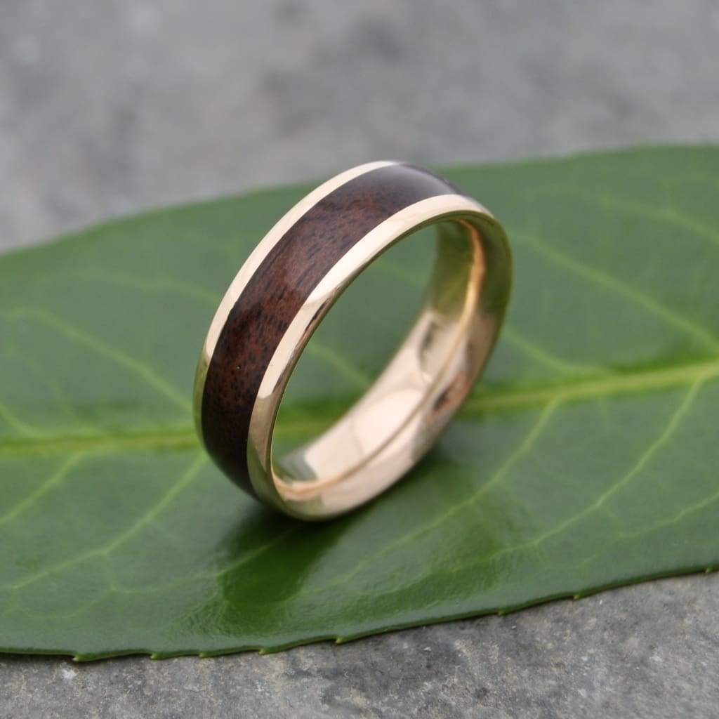 Men’s walnut wood wedding ring lined with solid 14k recycled yellow gold.