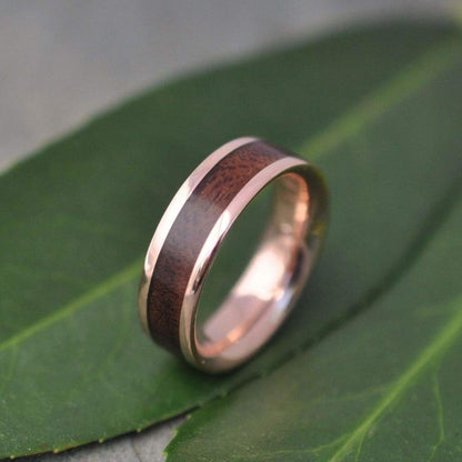 Rose gold and wood ring showing walnut grain and pink gold detail