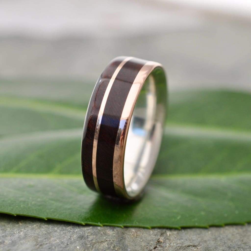 Rose gold wood ring showing nacascolo grain and offset rose gold and silver detail