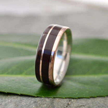 Rose gold wood ring showing nacascolo grain and offset rose gold and silver detail