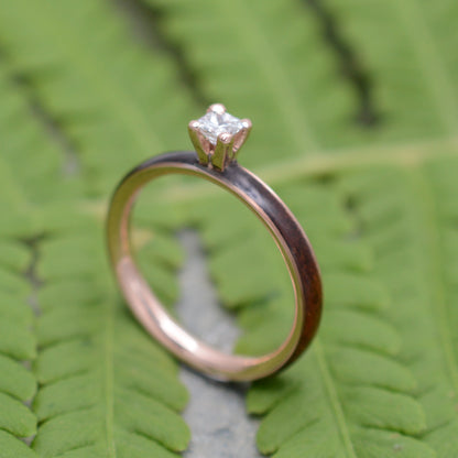 Rose gold diamond wood engagement ring with koa wood and princess cut diamond close up of grain