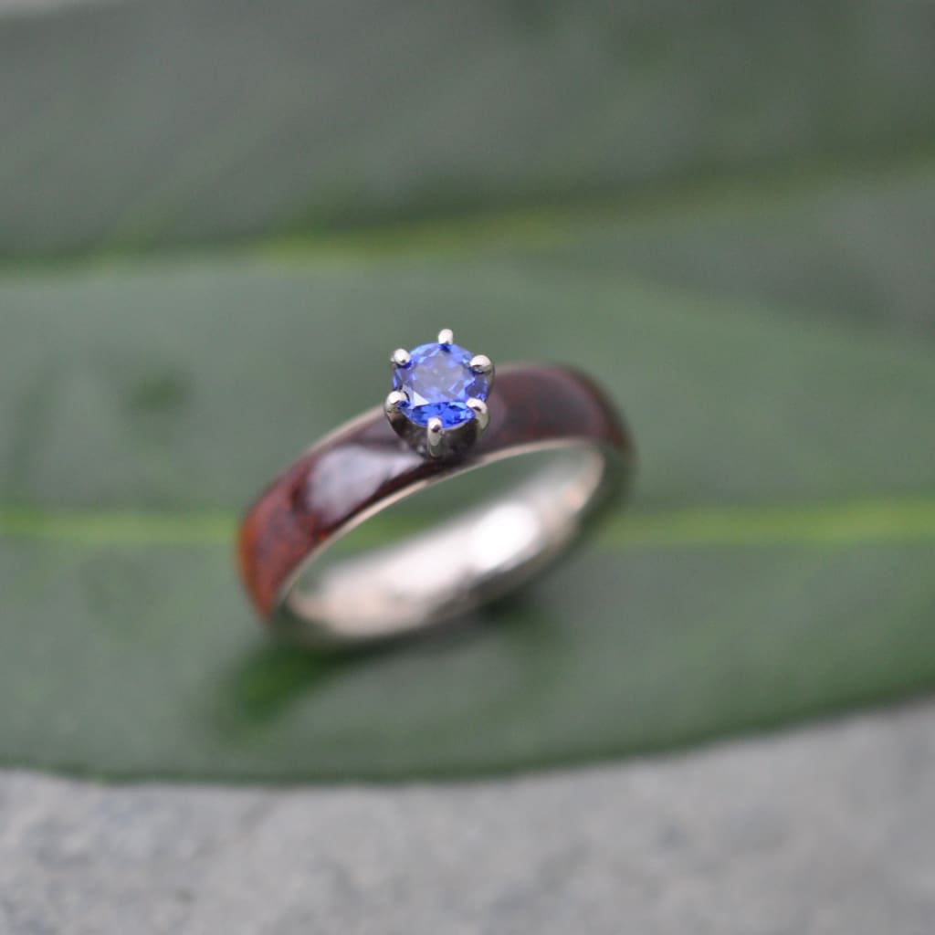 Sapphire and koa wood engagement ring with white gold on natural background