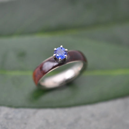 Sapphire and koa wood engagement ring with white gold on natural background