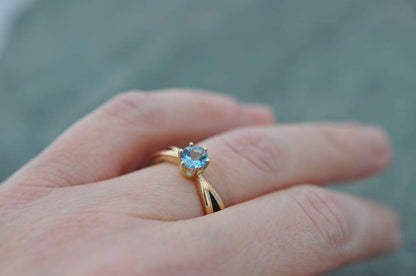 Unique engagement ring with aquamarine. Solitaire with tapered band, 14k recycled yellow gold and your choice of wood. Custom made in Louisville, Kentucky.