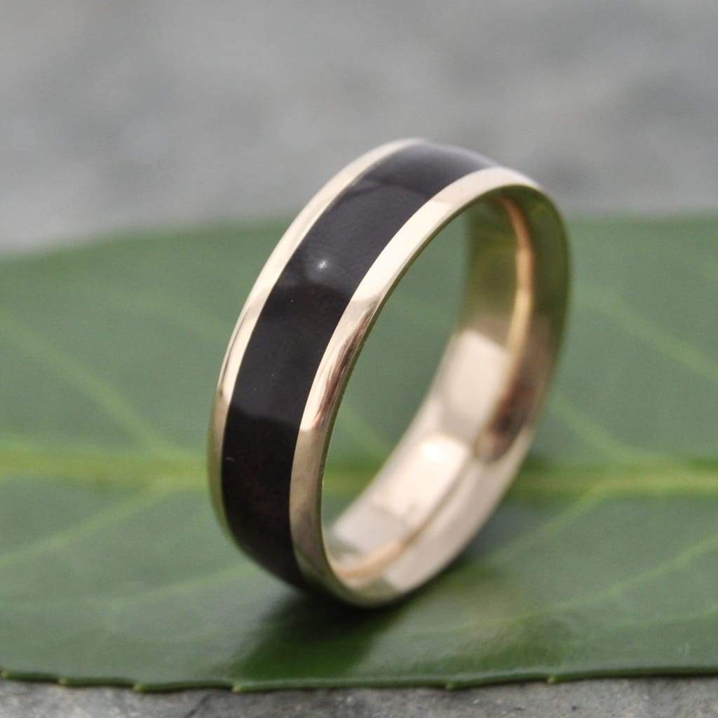 Eco-friendly walnut wood wedding ring with solid 14k recycled gold lining.