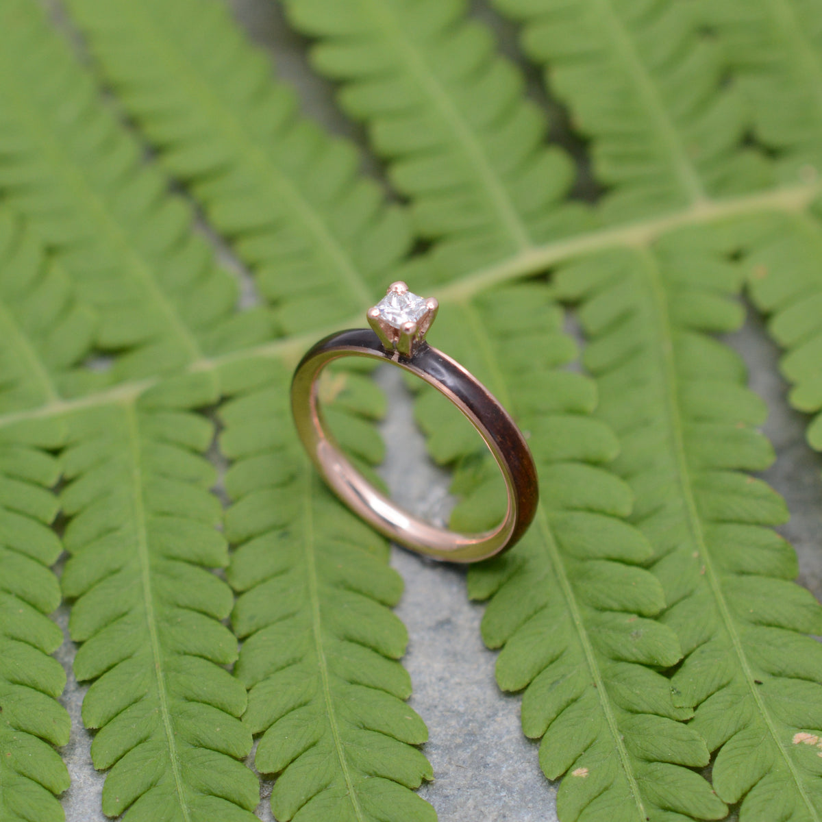 Rose gold diamond wood engagement ring with koa wood and princess cut diamond detail view