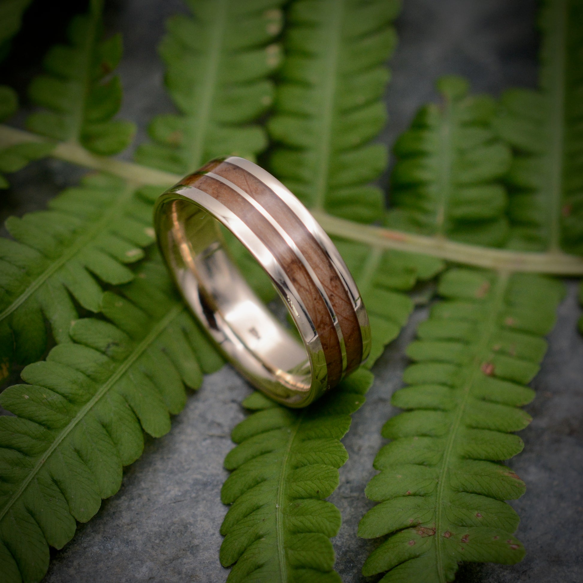 Whiskey barrel wood wedding band with recycled yellow gold, side view